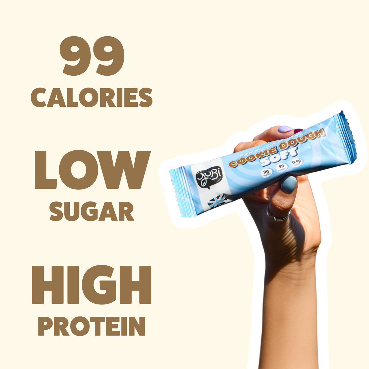 Hand holding a Cookie Dough Soft bar: 99 calories, low sugar, high protein
