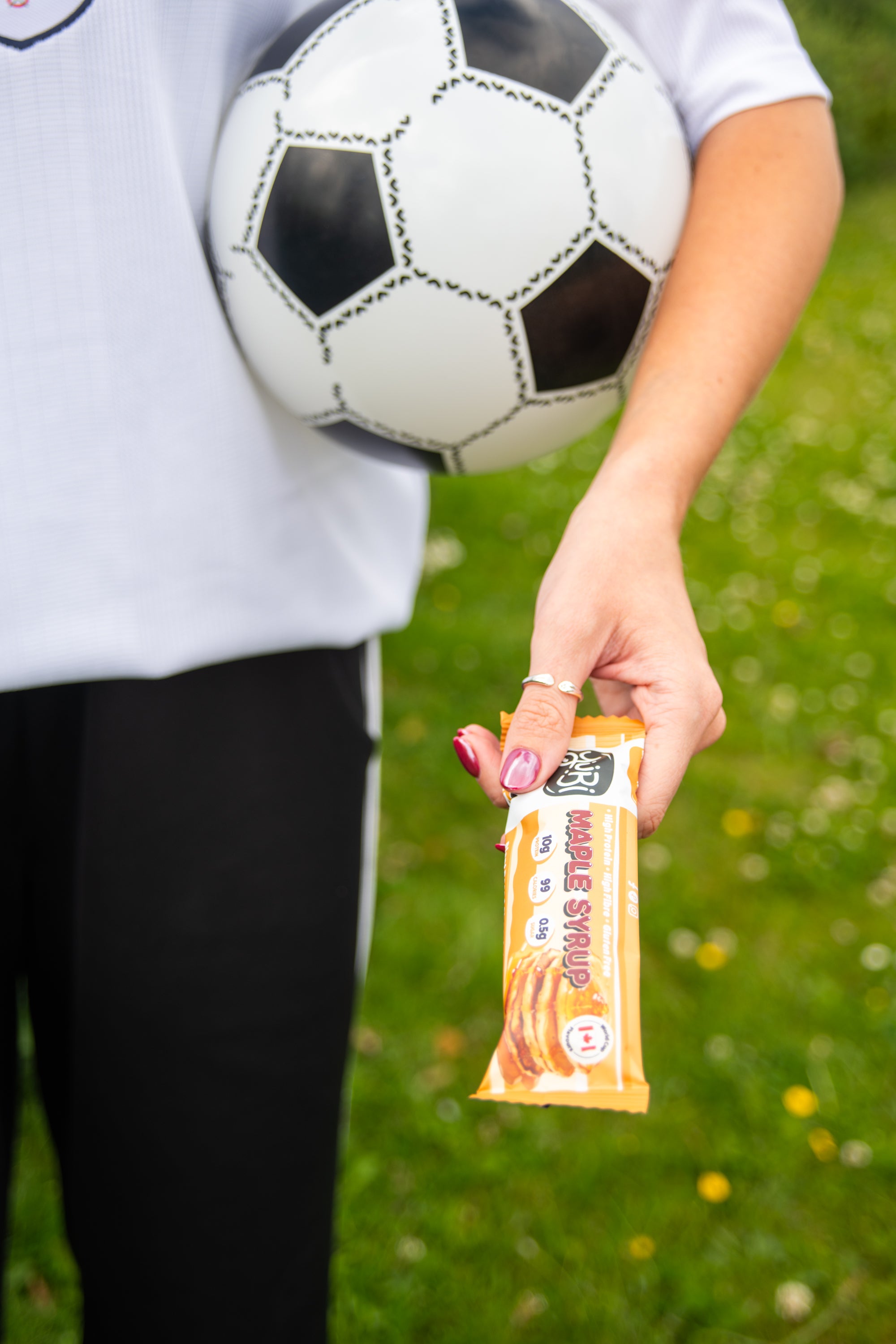 YuBi summer of soccer protein bars vegan gluten free low sugar maple syrup with woman in england football shirt