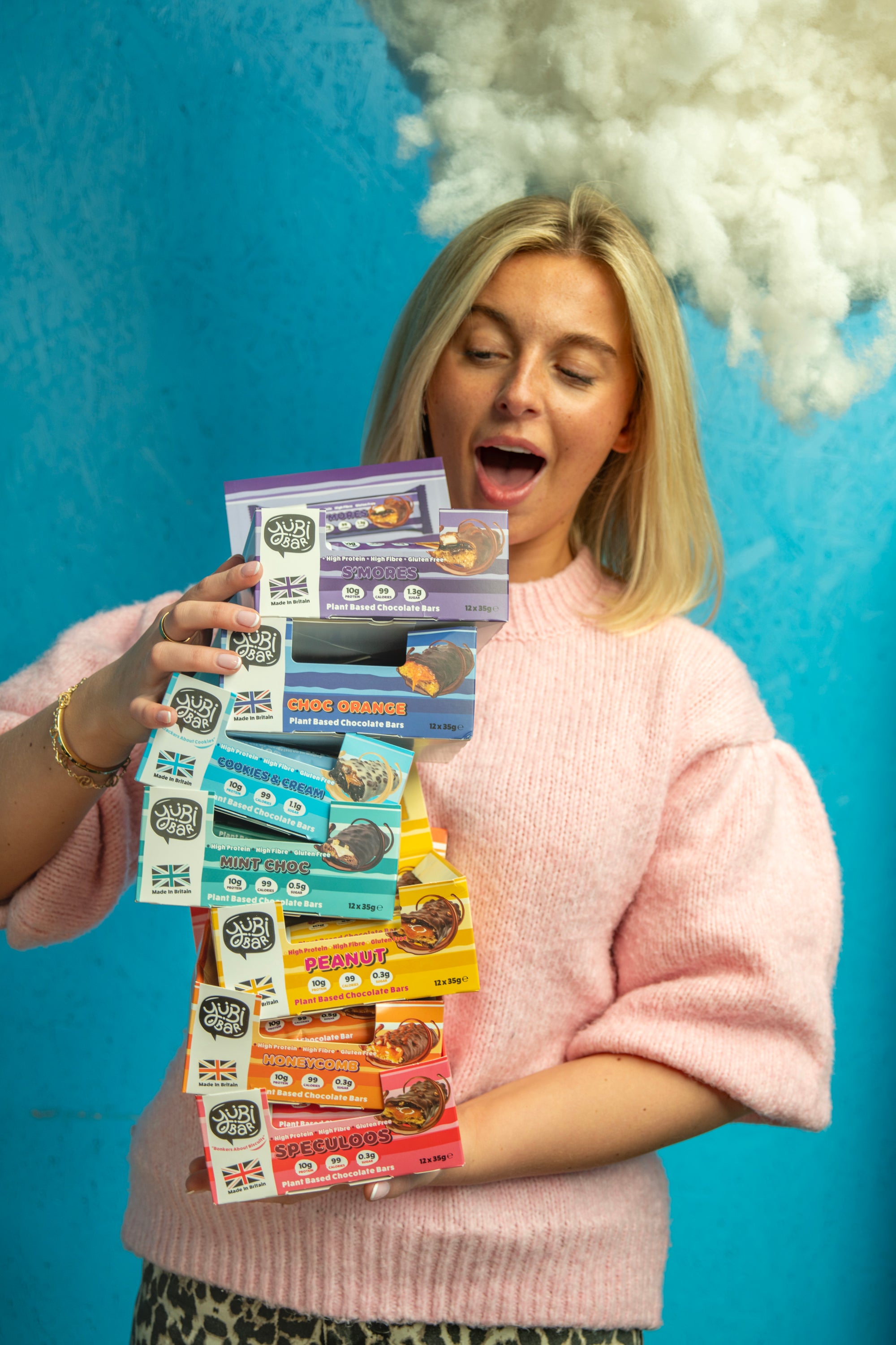 Woman with YubiBar Protein Bar haul low sugar 99 calorie plant based flavours