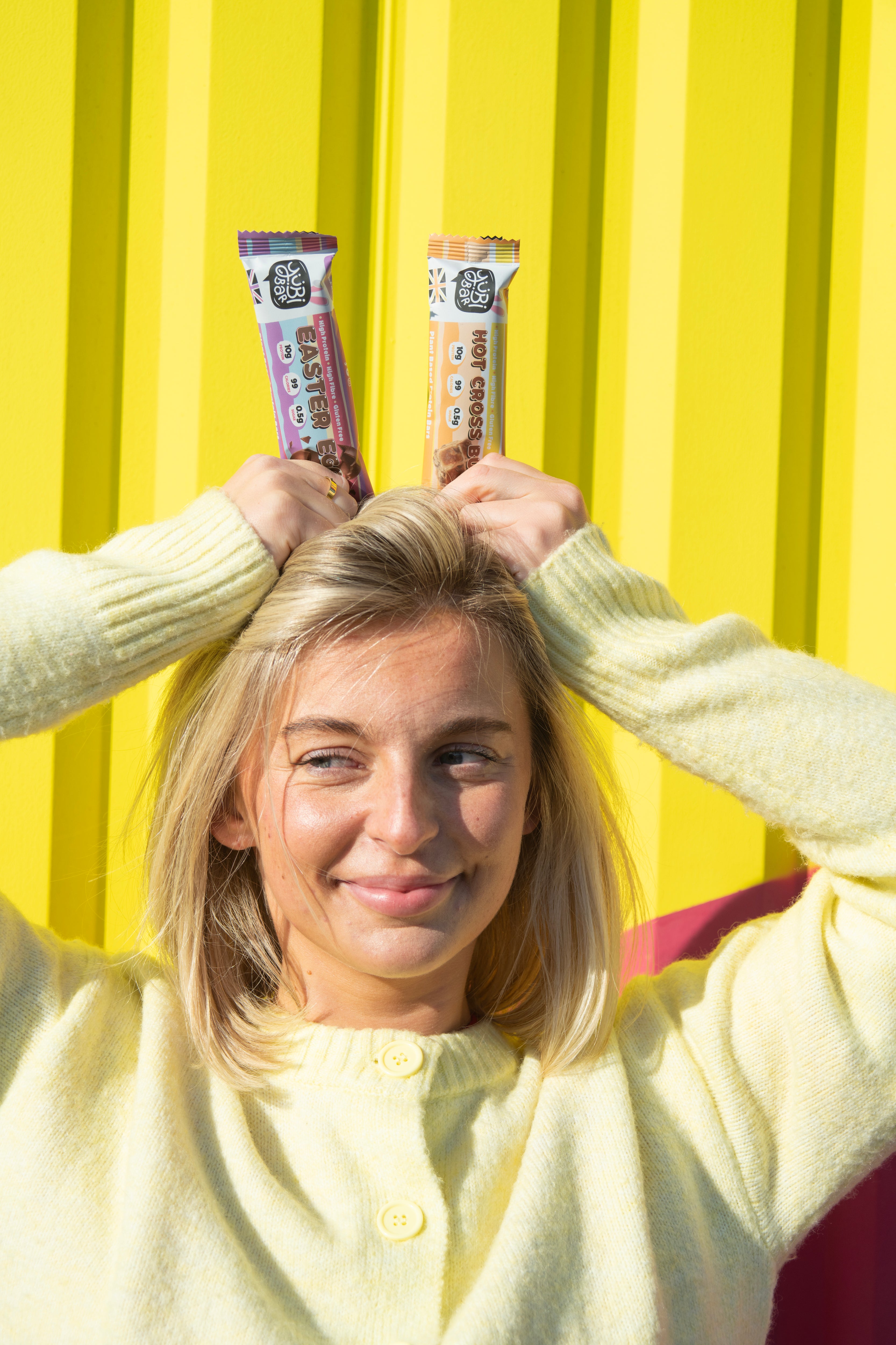 Woman with Easter Protein Bars as bunny ears