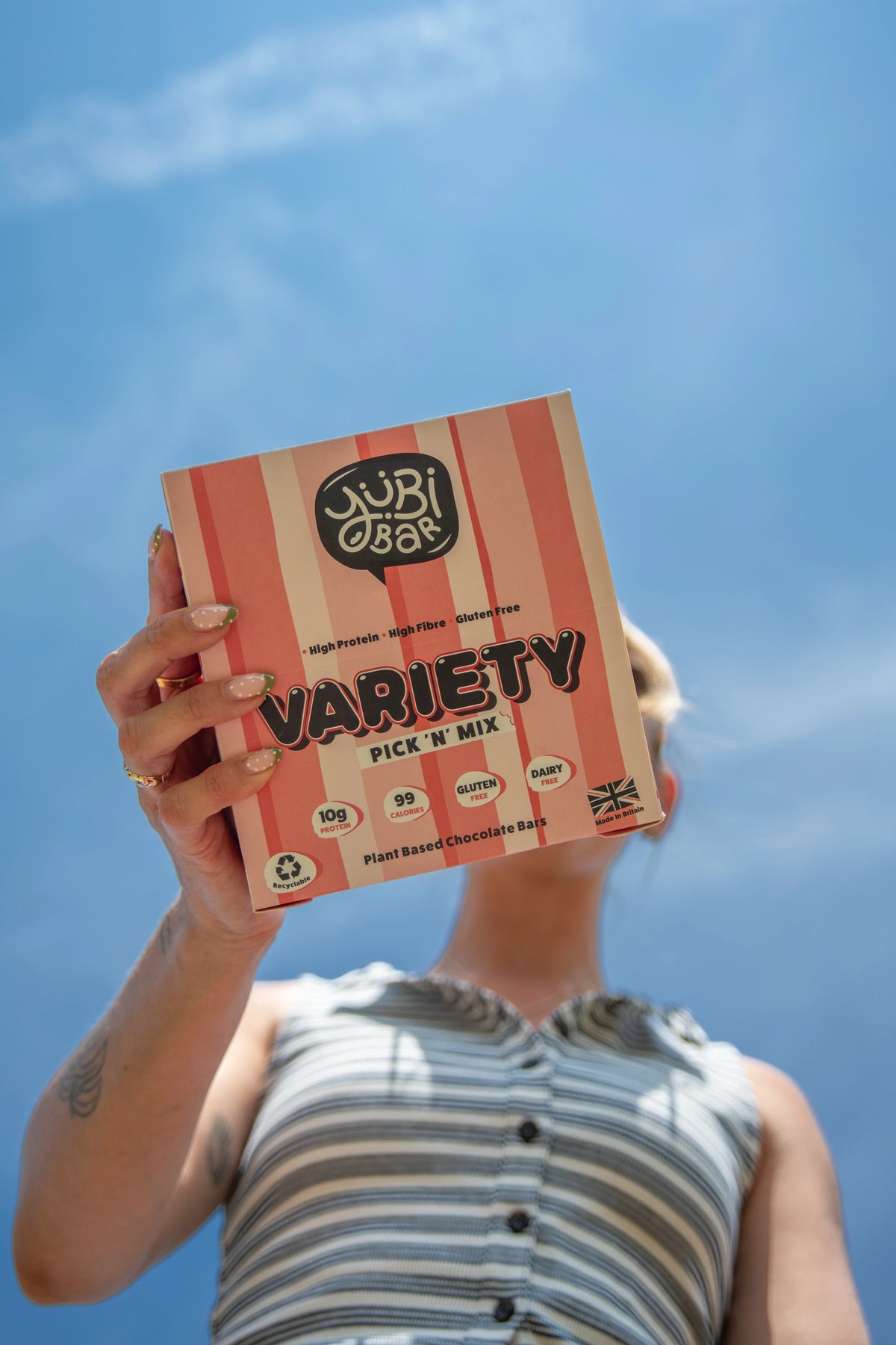 Woman holding YuBi Bar Variety Pick N Mix box