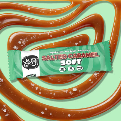 YuBi Salted Caramel Soft protein bar on a swirl of salted caramel
