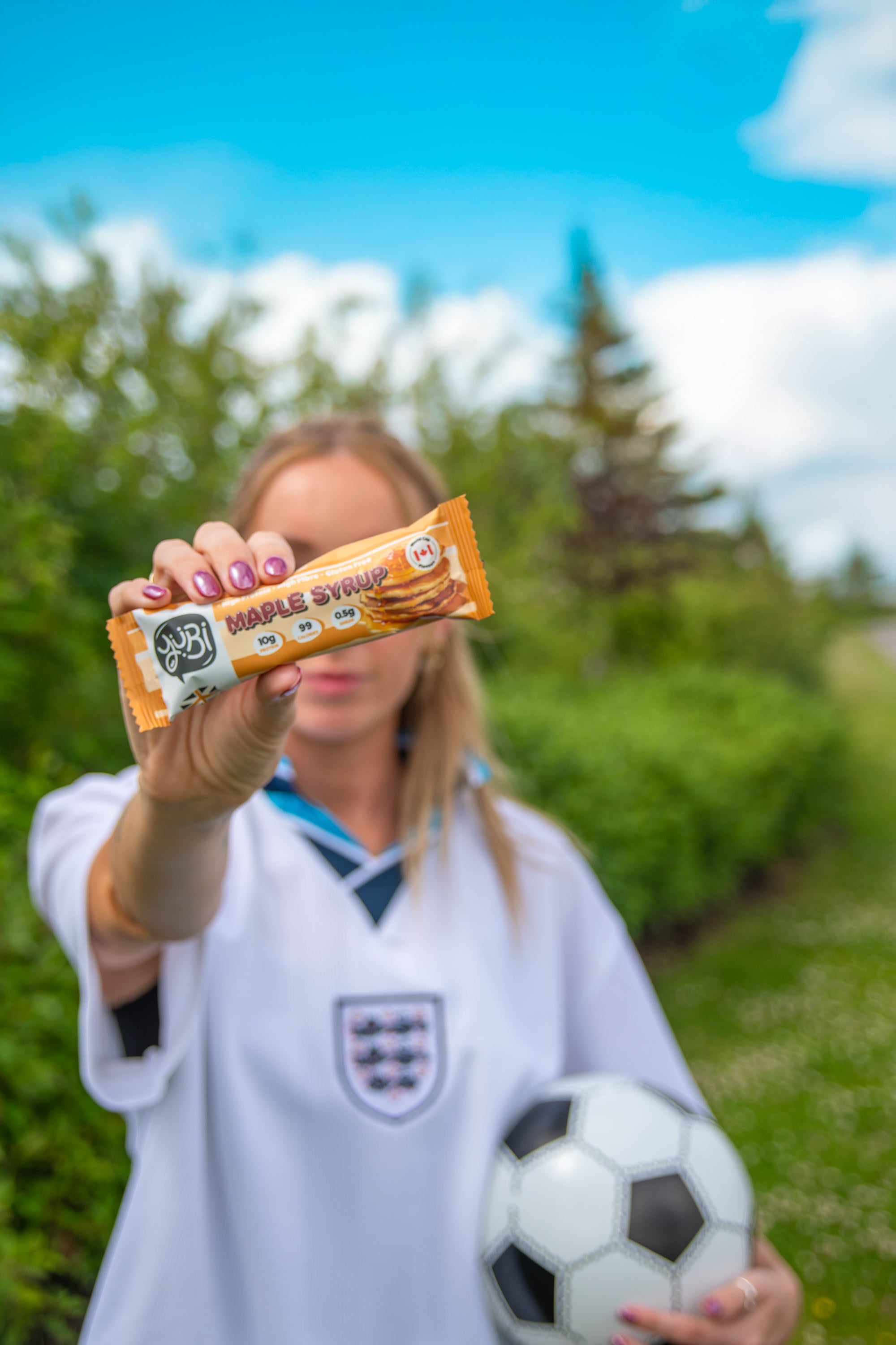 YuBi summer of soccer protein bars vegan gluten free low sugar maple syrup with woman in england football shirt
