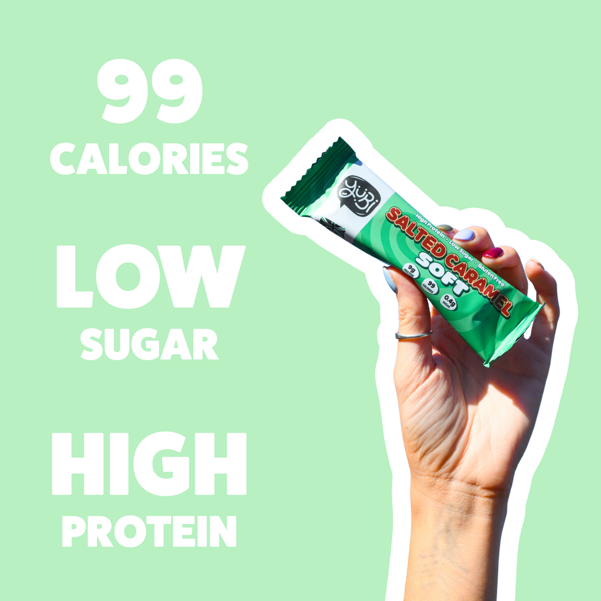 Hand holding a Salted Caramel Soft bar: 99 calories, low sugar, high protein